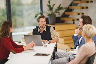 Business team meeting in modern office with laptop