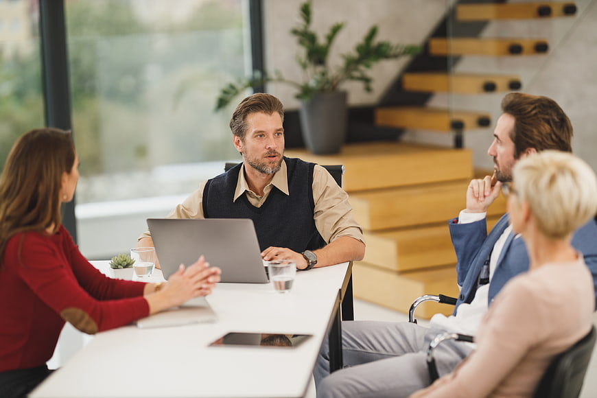 Business team meeting in modern office with laptop