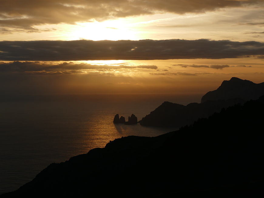 Dramatic Sunset Over Coastal Sea Stacks and Silhouetted Cliffs