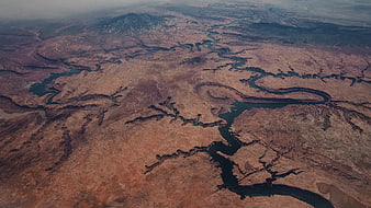 Aerial View of Winding River Through Arid Desert Landscape