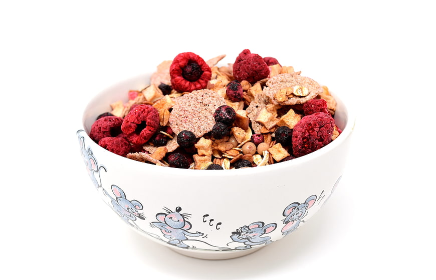 White Bowl With Cartoon Mice Filled With Muesli And Dried Raspberries