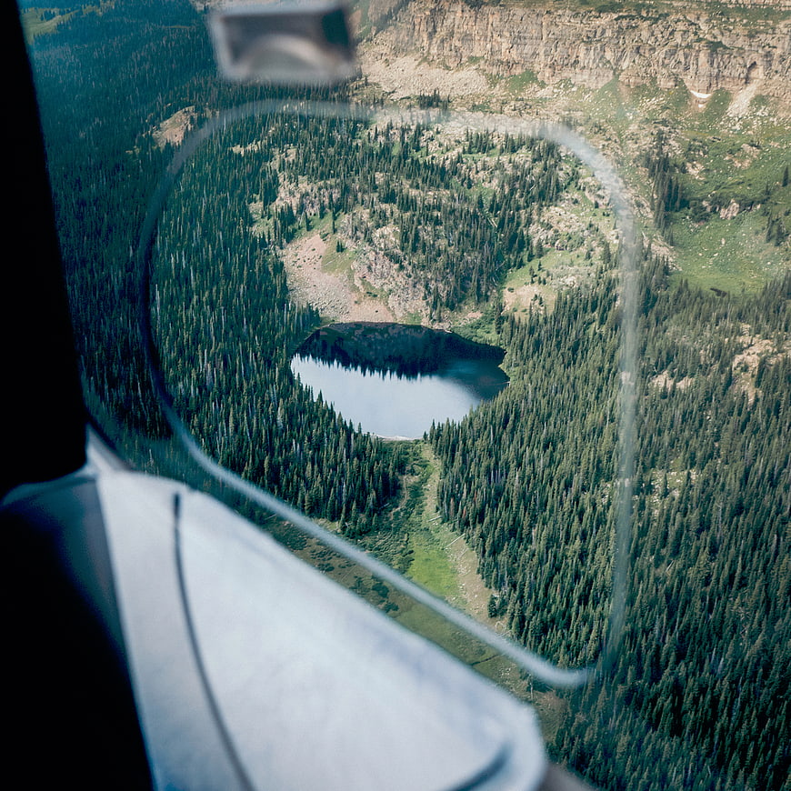 Aerial View of Mountain Lake Through Helicopter Window