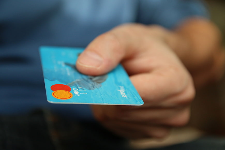 Hand Holding Blue Debit Card Close Up