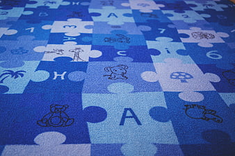 Blue interlocking foam puzzle mat with letters and animals