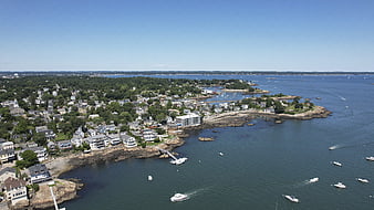 Aerial view of coastal town with boats on blue water