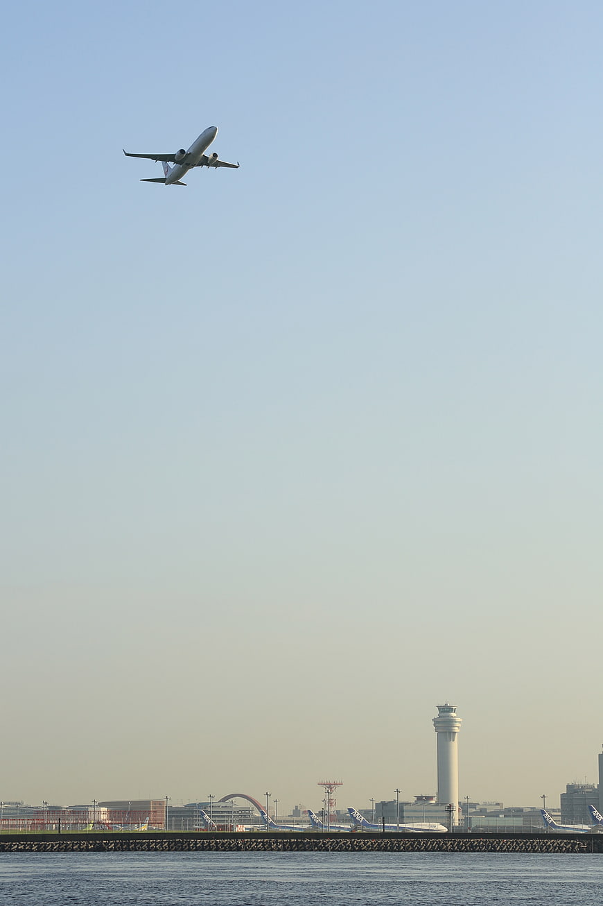 Airplane Taking Off Over Airport and Ocean