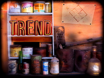 Vintage neon trend sign with antique tins and rusty tools