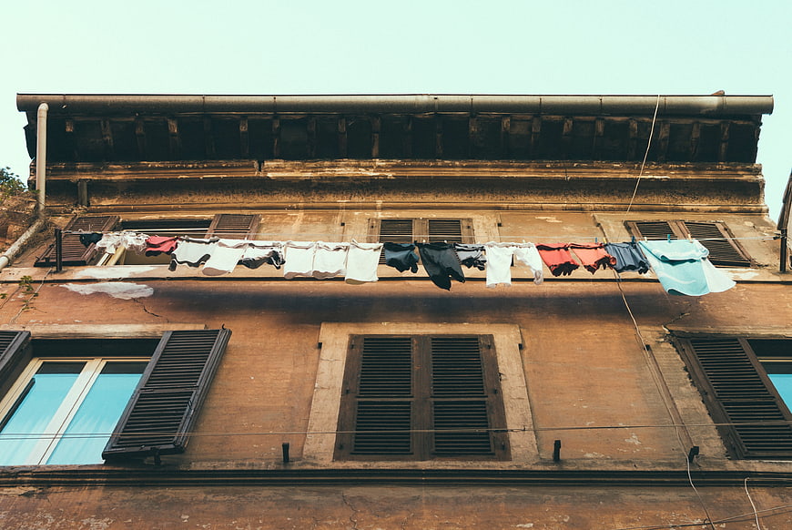 Laundry hanging on clothesline against old European building facade
