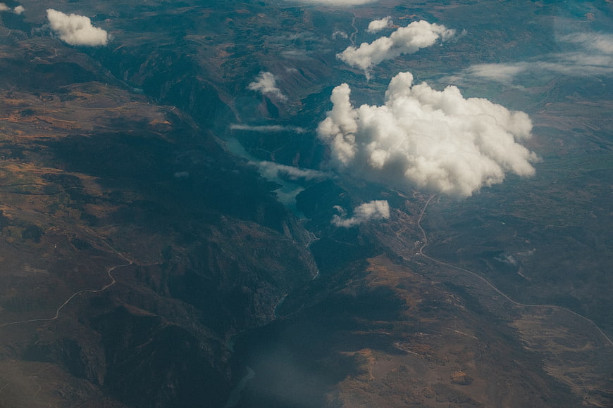 Aerial View of Mountain Valley with Clouds