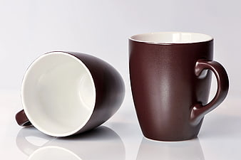 Two Brown Ceramic Mugs on White Background