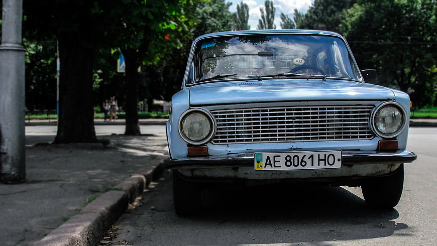 Front view of vintage light blue Soviet car parked on street