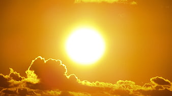 Bright Sun with Golden Clouds in Orange Sky