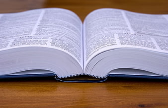 Open Thesaurus Book on Wooden Table