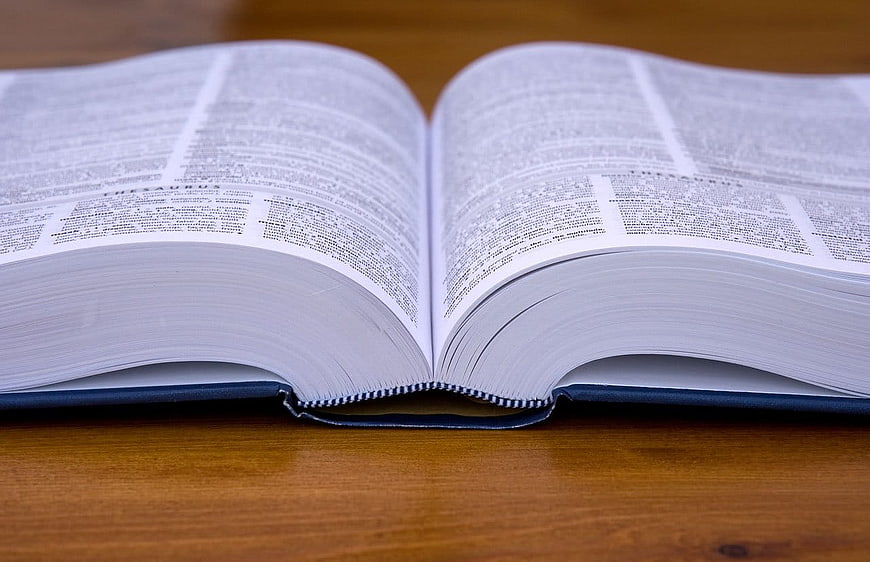 Open Thesaurus Book on Wooden Table