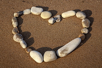 Heart Shape Made Of Smooth Stones On Sandy Beach