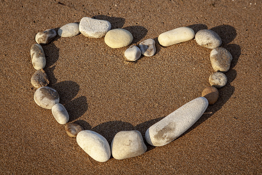 Heart Shape Made Of Smooth Stones On Sandy Beach