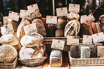 Artisan Bread Display in Wicker Baskets with Price Tags