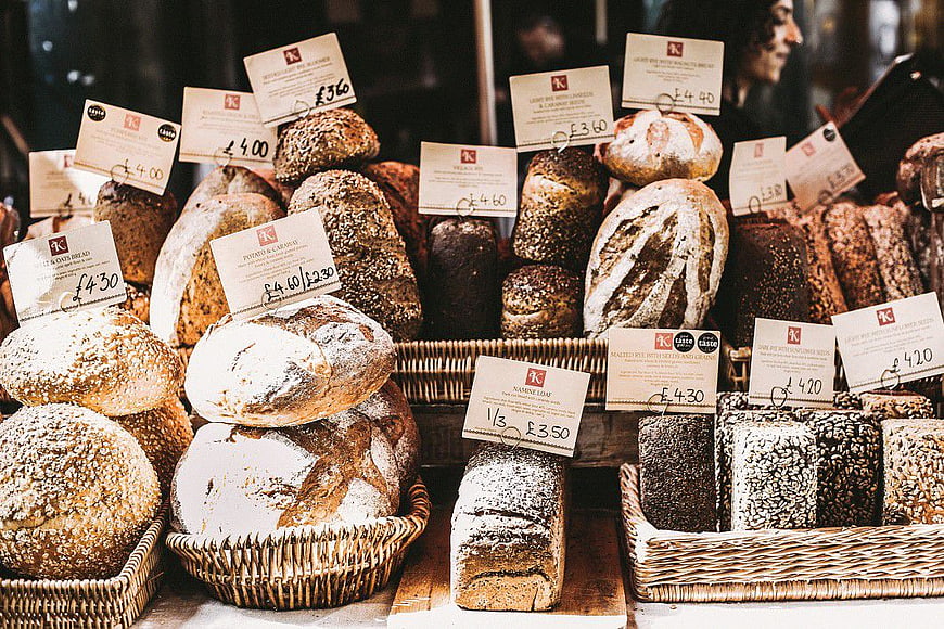 Artisan Bread Display in Wicker Baskets with Price Tags