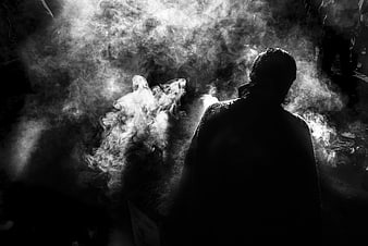 Silhouette of person in smoke during Andean ritual ceremony