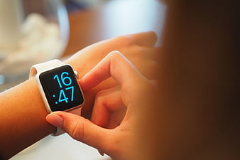 Close-up of Woman Checking White Smartwatch