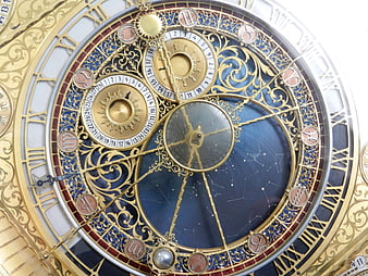 Close-up of ornate astronomical clock face with gold details