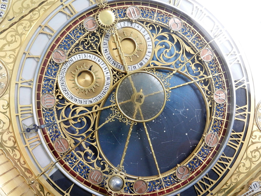 Close-up of ornate astronomical clock face with gold details