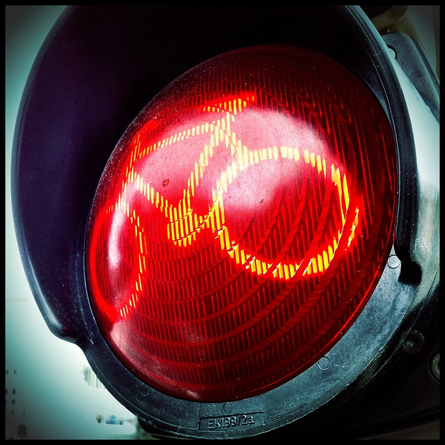 Close-up of Red Traffic Light Signal with Reflections