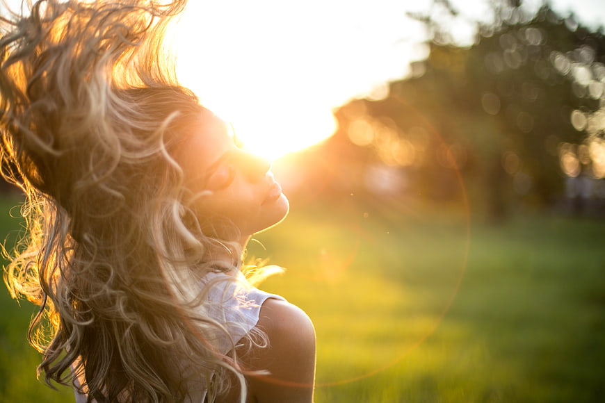 Woman with flowing hair in golden sunlight