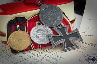 Historical WWII German Military Medals and Iron Cross on Vintage Documents