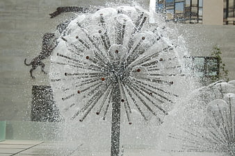 Modern dandelion water fountain sculpture spraying jets