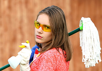 Young Woman with Cleaning Supplies and Safety Goggles