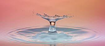 Macro water droplet splash with ripples on pastel gradient background