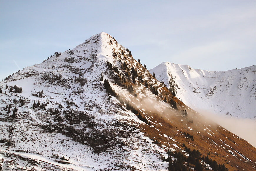 Snow-Covered Mountain Peak with Misty Slopes
