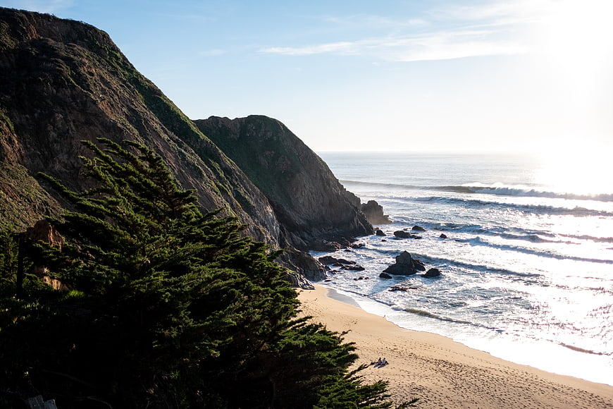 Scenic coastal cliffs with pine trees and ocean waves