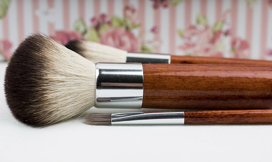 Wooden Handle Makeup Brushes With Silver Ferrules On White Surface