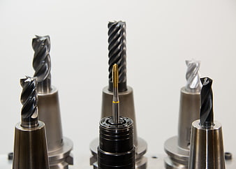 Assortment of CNC milling cutters and drill bits in collets