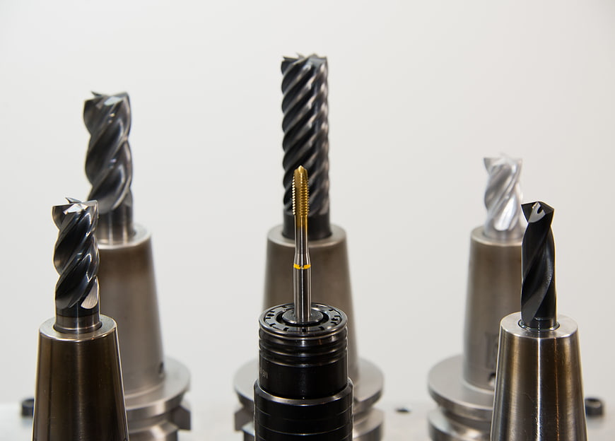 Assortment of CNC milling cutters and drill bits in collets