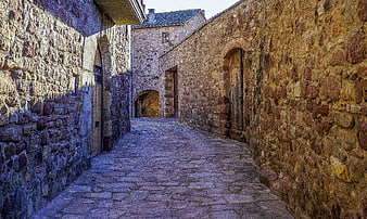 Narrow Cobblestone Alleyway In Historic European Stone Village