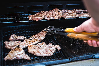Grilling Beef Steaks on Outdoor BBQ Grill