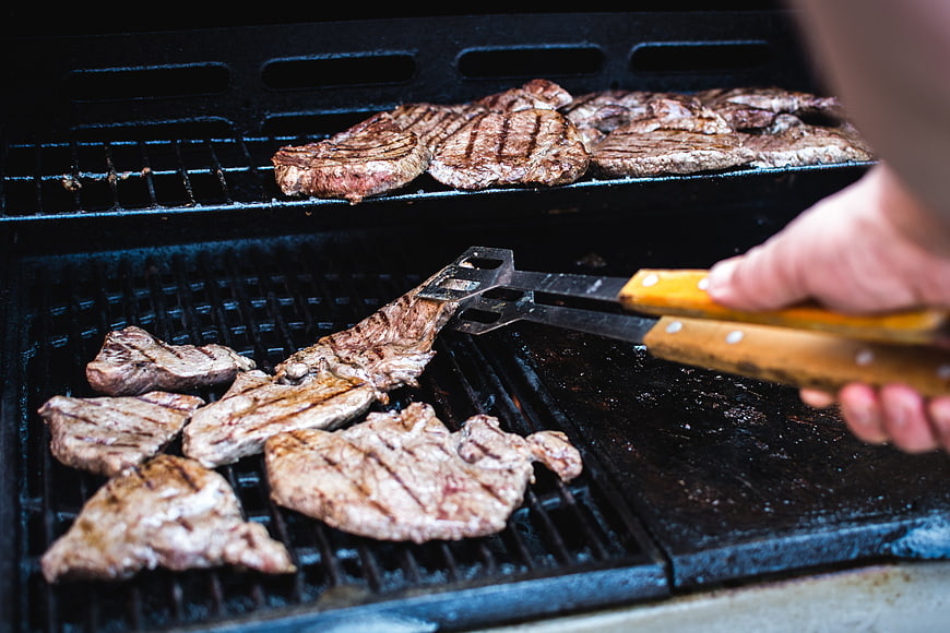Grilling Beef Steaks on Outdoor BBQ Grill