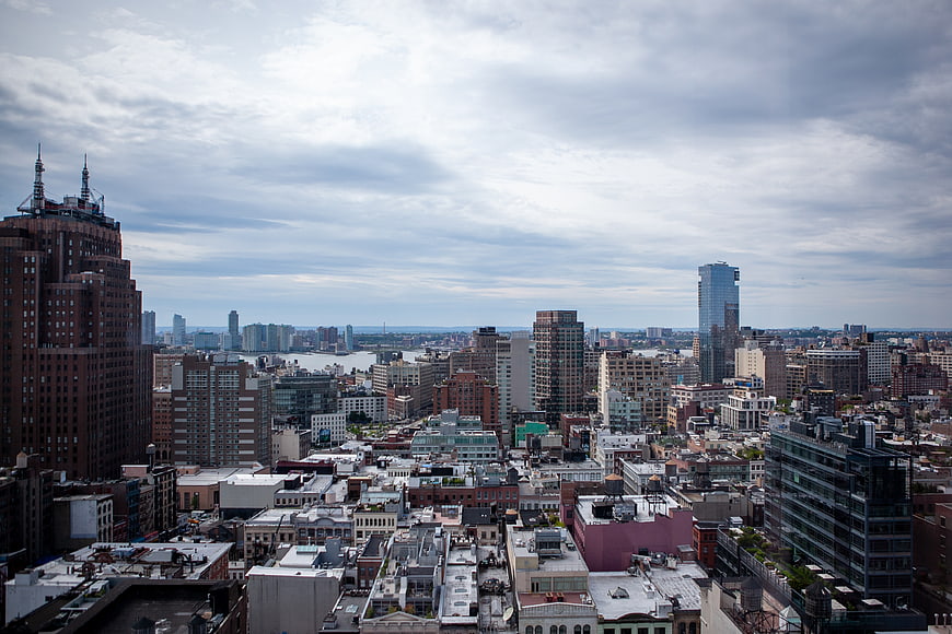 Overhead View of Urban Cityscape with Skyscrapers and Cloudy Sky