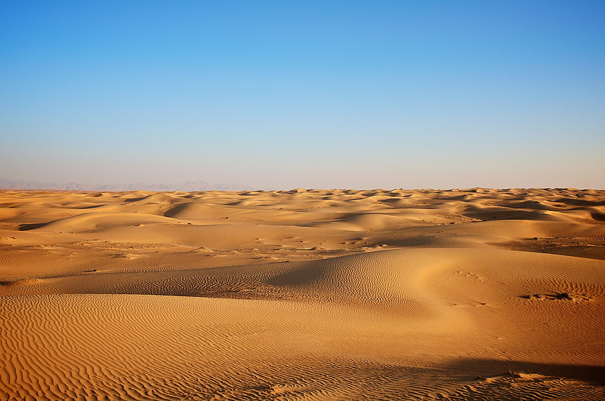 Golden Sand Dunes Under Clear Blue Sky Desert Landscape