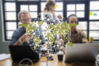 Global Digital Network Overlay On Blurred Business Team Meeting