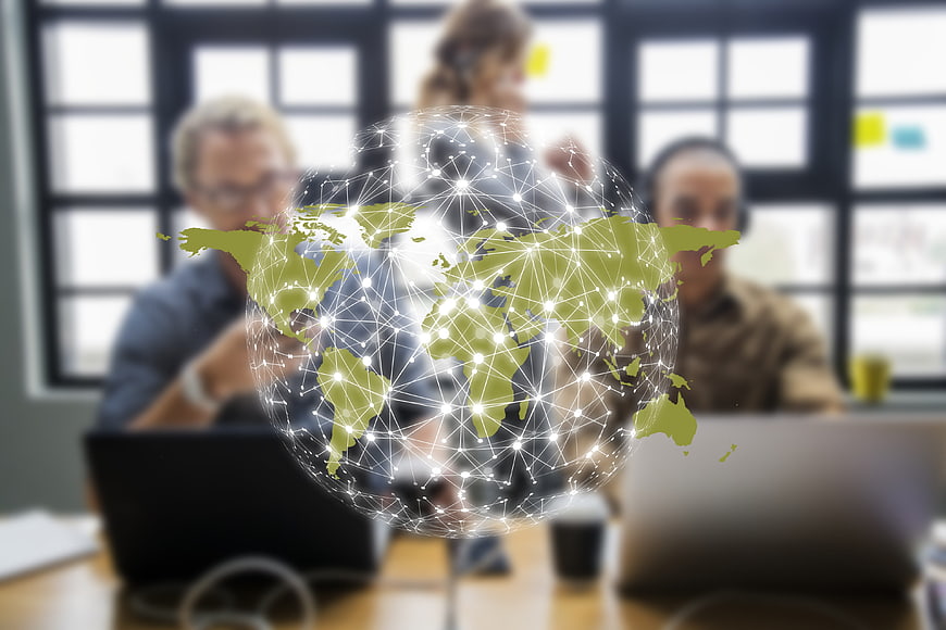 Global Digital Network Overlay On Blurred Business Team Meeting