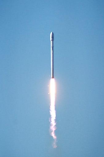 SpaceX Falcon 9 Rocket Launching into Blue Sky