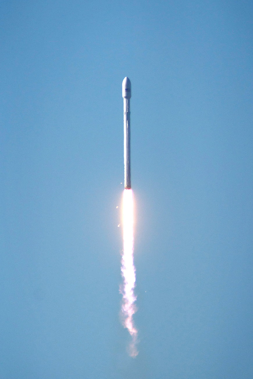SpaceX Falcon 9 Rocket Launching into Blue Sky
