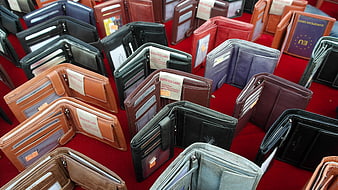 Assorted Leather Wallets Displayed On Red Market Table