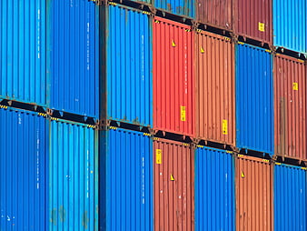 Stacked Blue and Red Shipping Containers in Industrial Port