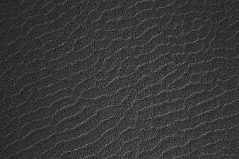 Dark textured sand ripples pattern background