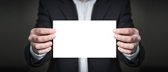 Businessman holding blank white card for text overlay